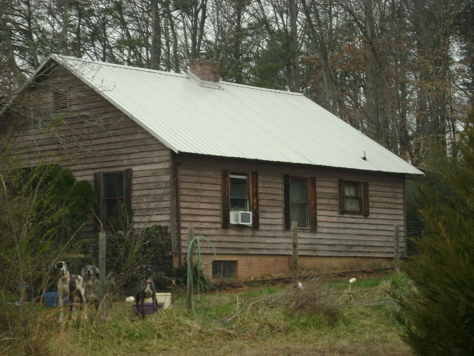 White metal roof on an old wood sided farmhouse, from a Metal Roof Installation job in Aragon