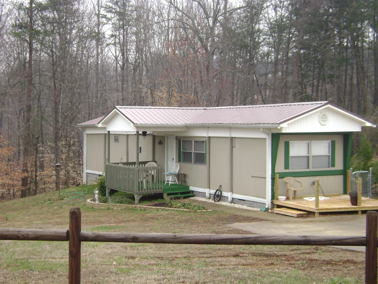 Mauve metal roof on a manufactured home with a new front deck in Aragon